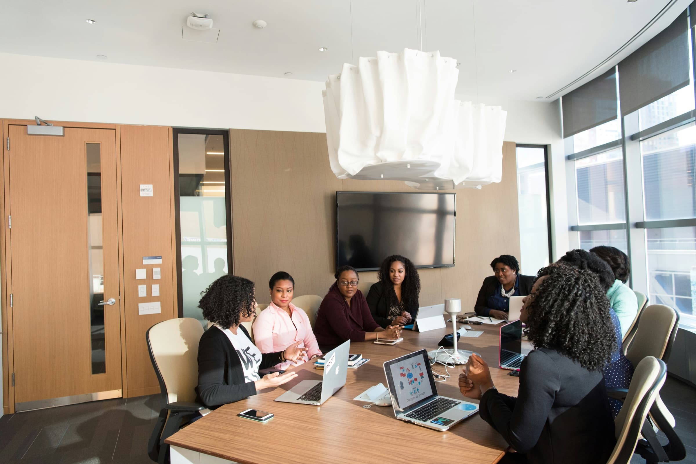 Colleagues working through a discussion around a conference table